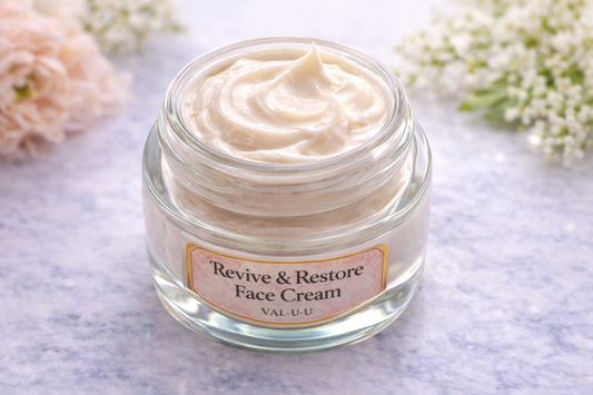 Jar of 'Revive & Restore Face Cream' on a light background with flowers.