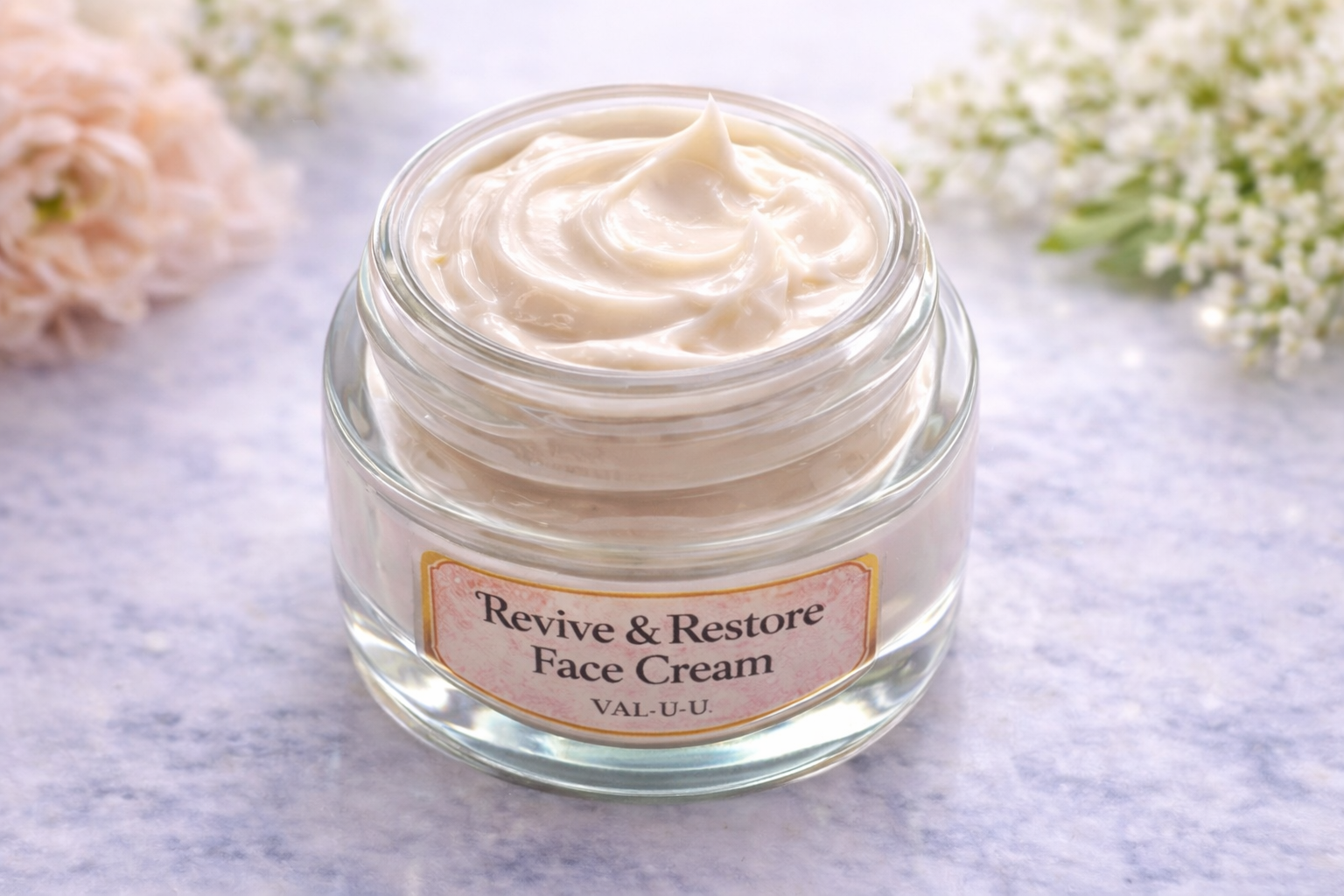 Jar of 'Revive & Restore Face Cream' on a light background with flowers.