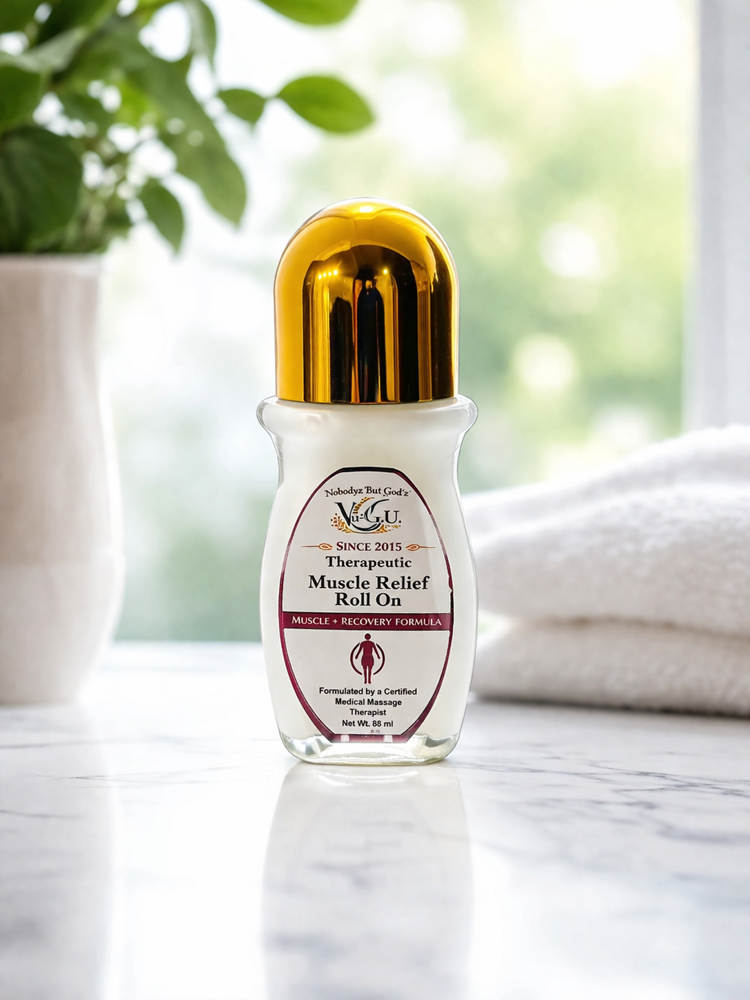 Therapeutic Muscle Relief Roll On bottle on a marble surface with a blurred natural background